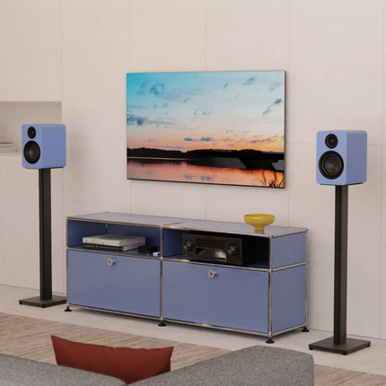 Kanto ST Series stands in Matte Black with bookshelf speakers, in a living room