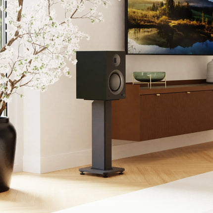 Kanto SX Series stands in Matte Black with bookshelf speakers, in a living room