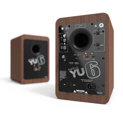Rear panels of the Kanto Audio YU6 pair in walnut: the active speaker with RCA, AUX, two optical inputs and subwoofer output